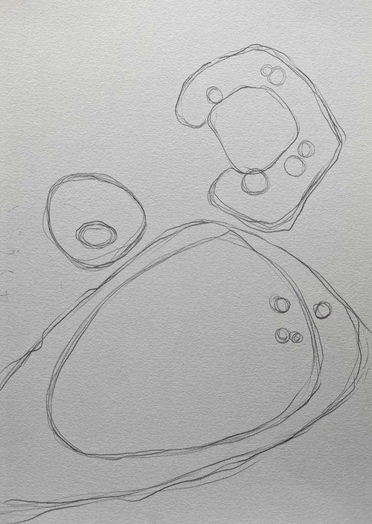 Drawing of large oval shape and two smaller round shapes above